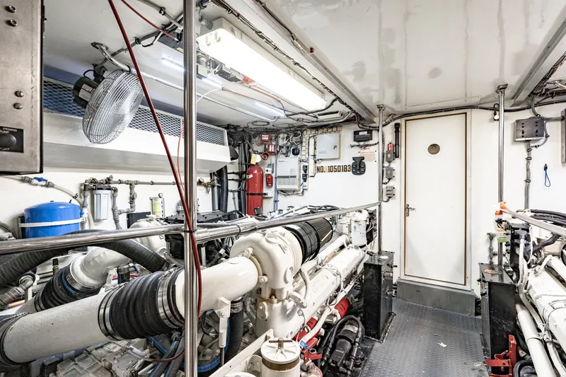 Slide: The Image of Engine room of a 1996 Hatteras 70 Sport Deck Motor Yacht, showcasing machinery and equipment. - 72