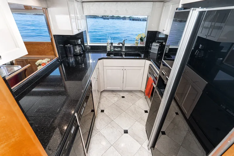 Slide: The Image of Luxurious kitchen interior of 1996 Hatteras 70 Sport Deck Motor Yacht with ocean view. - 44