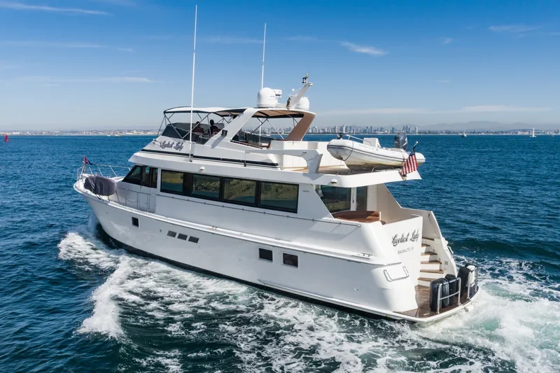 Slide: The Image of 1996 Hatteras 70 Sport Deck Motor Yacht cruising on open water. - 5