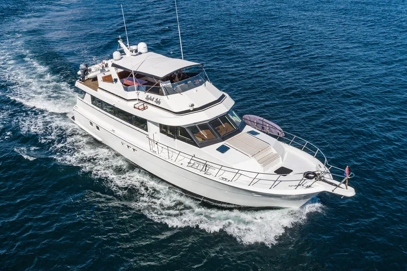 Slide: The Image of 1996 Hatteras 70 Sport Deck Motor Yacht cruising on open water. - 6