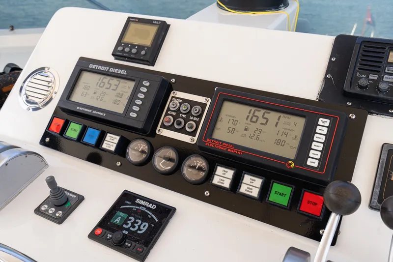 Slide: The Image of Control panel of a 1996 Hatteras 70 Sport Deck Motor Yacht with Detroit Diesel displays. - 29