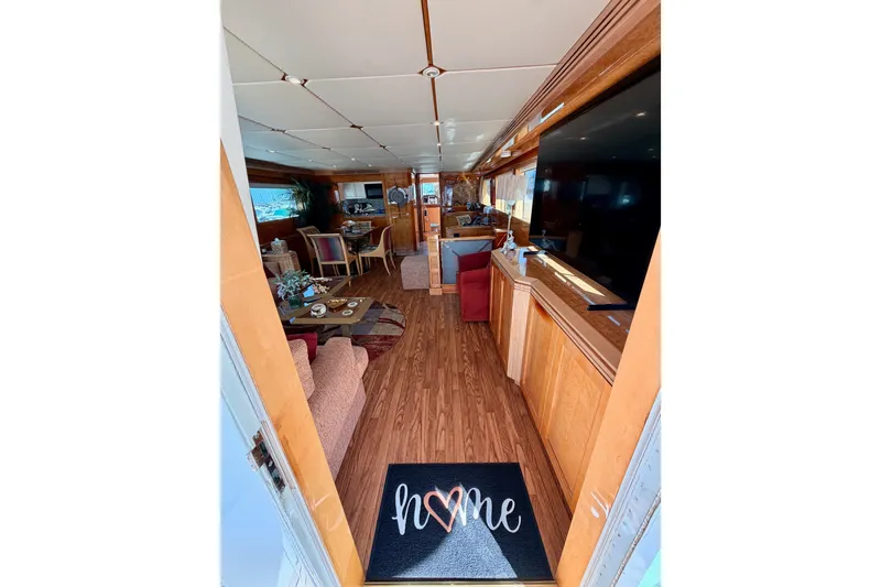 Slide: The Image of Interior of 1996 Hatteras 70 Sport Deck Motor Yacht, featuring cozy living space and decor. - 34