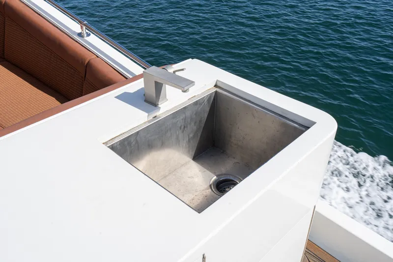 Slide: The Image of Outdoor sink on 1996 Hatteras 70 Sport Deck Motor Yacht, near ocean. - 16