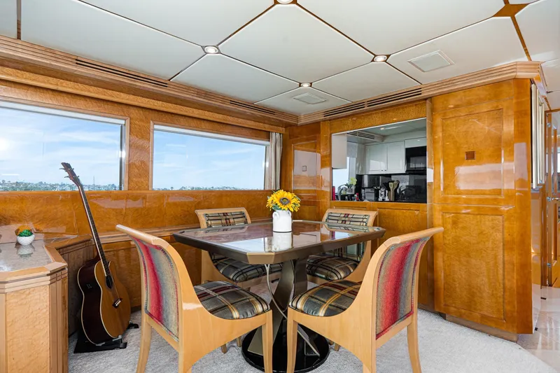 Slide: The Image of Luxurious interior of 1996 Hatteras 70 Sport Deck Motor Yacht with dining area and guitar. - 40