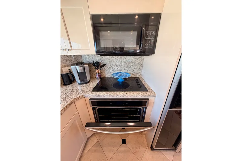 Slide: The Image of Modern kitchen in 1996 Hatteras 70 Sport Deck Motor Yacht with appliances and granite countertops. - 50