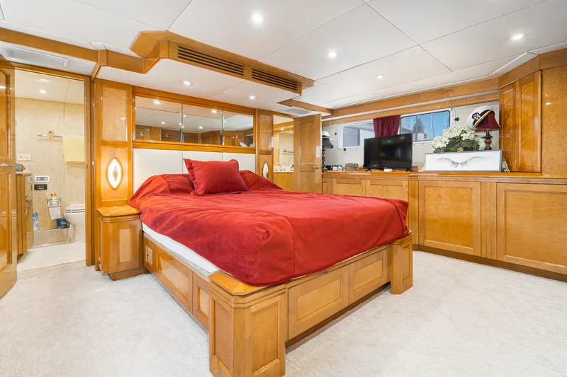 Slide: The Image of Luxurious bedroom interior of 1996 Hatteras 70 Sport Deck Motor Yacht with red bedding. - 51