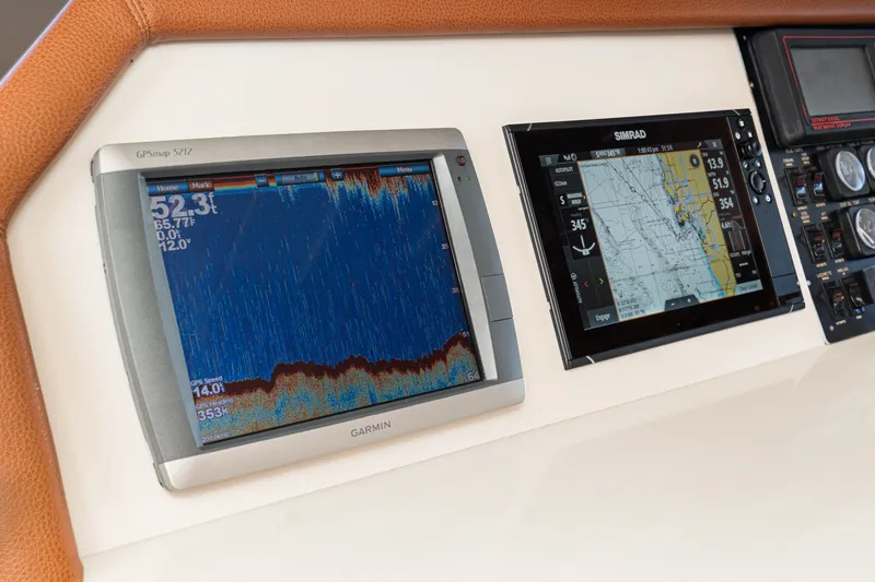 Slide: The Image of Navigation equipment on 1996 Hatteras 70 Sport Deck Motor Yacht, featuring Garmin and Simrad displays. - 47