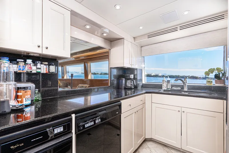 Slide: The Image of Luxurious kitchen interior of 1996 Hatteras 70 Sport Deck Motor Yacht with ocean view. - 38