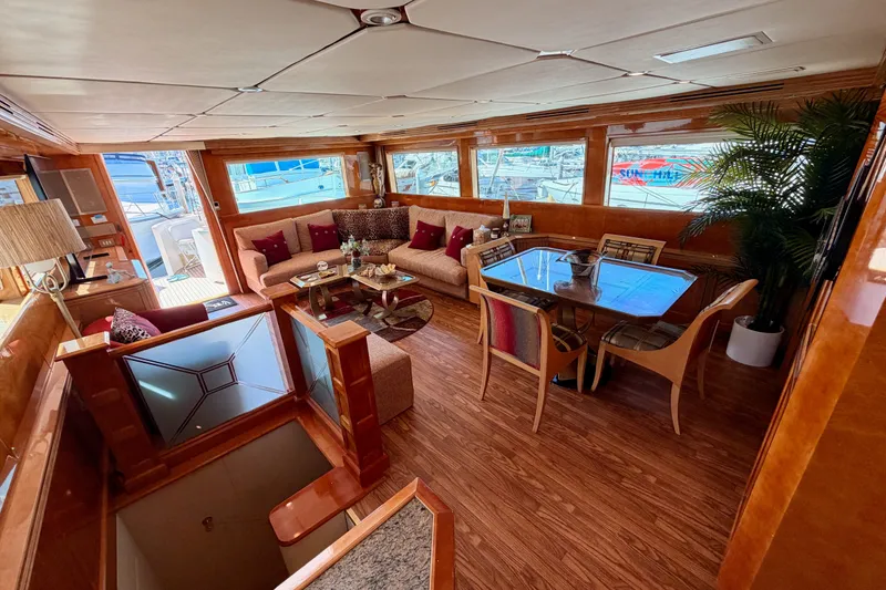Slide: The Image of Luxurious interior of a 1996 Hatteras 70 Sport Deck Motor Yacht with elegant seating and dining area. - 38