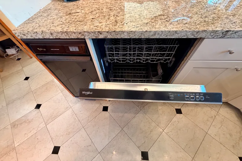 Slide: The Image of Kitchen area of 1996 Hatteras 70 Sport Deck Motor Yacht with Whirlpool dishwasher. - 49