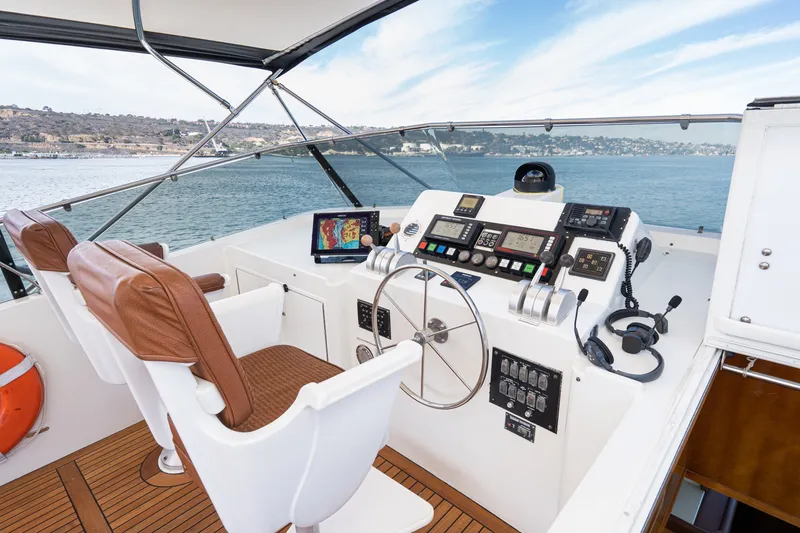 Slide: The Image of Helm of 1996 Hatteras 70 Sport Deck Motor Yacht with navigation equipment and scenic view. - 26