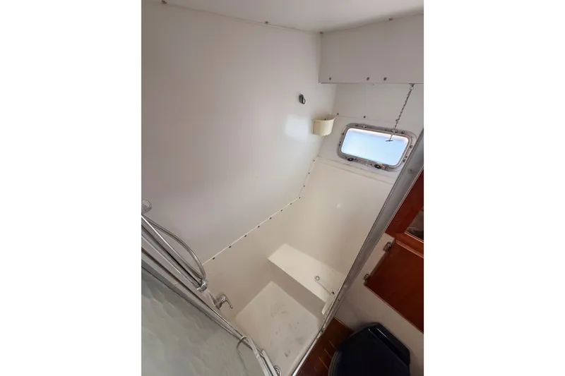 Slide: The Image of Interior of 1982 Bertram 54 Convertible yacht bathroom with shower and window. - 67