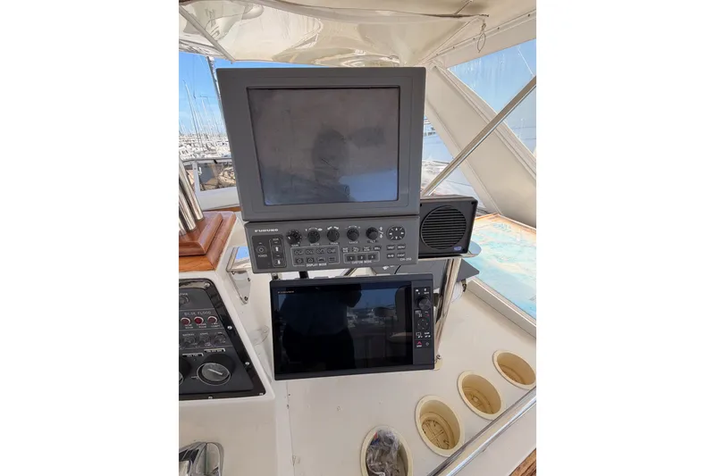 Slide: The Image of Control panel of a 1982 Bertram 54 Convertible yacht with navigation equipment. - 31