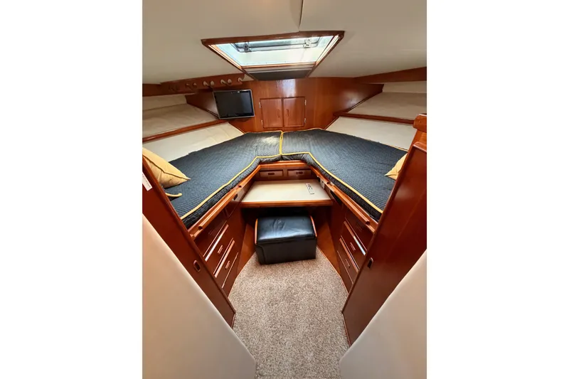 Slide: The Image of Luxurious cabin interior of 1982 Bertram 54 Convertible yacht with wood finish and cozy bedding. - 69