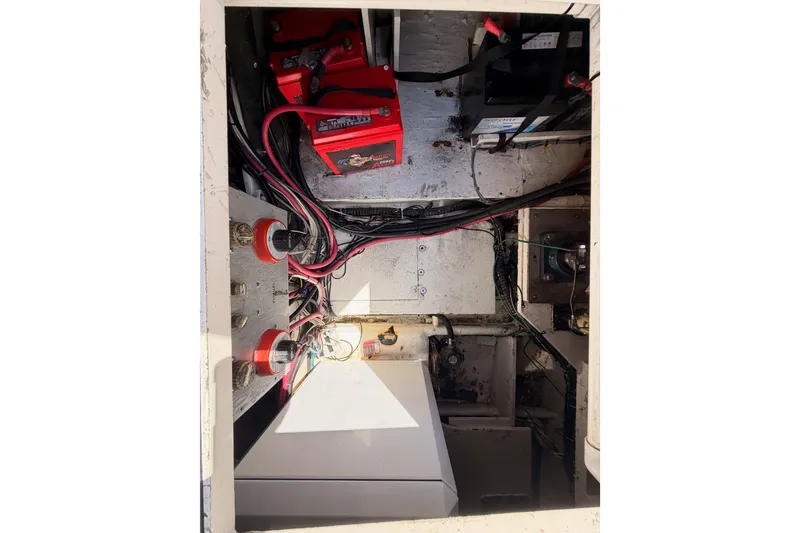 Slide: The Image of Electrical compartment of a 1982 Bertram 54 Convertible boat with batteries and wiring. - 43