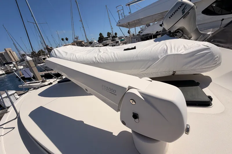 Slide: The Image of 1982 Bertram 54 Convertible yacht deck with covered equipment and marina view. - 22