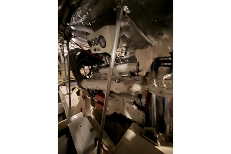 Slide: The Image of Engine room of a 1982 Bertram 54 Convertible yacht, showcasing mechanical components. - 93