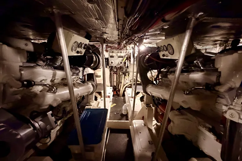 Slide: The Image of Engine room of a 1982 Bertram 54 Convertible yacht, showcasing dual engines and control panels. - 91