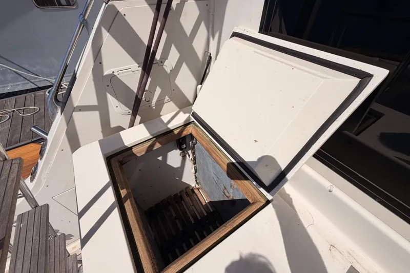 Slide: The Image of Open hatch on 1982 Bertram 54 Convertible boat deck, showing interior storage space. - 39