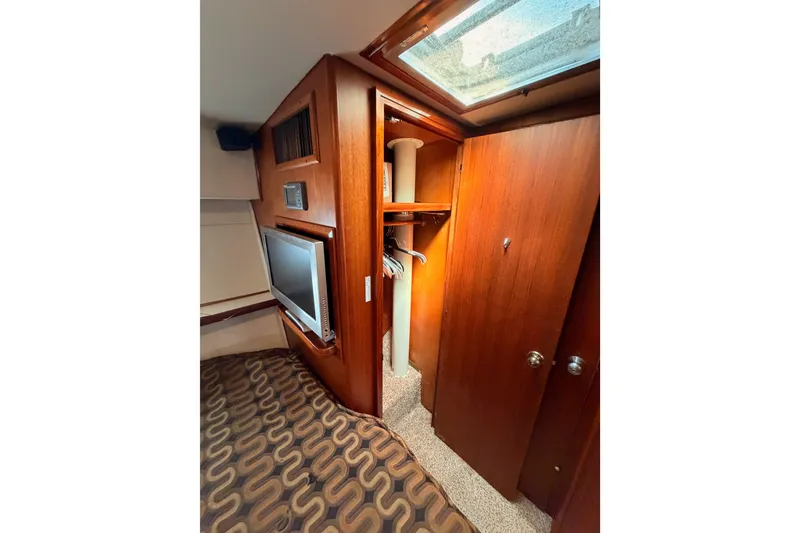 Slide: The Image of Interior of 1982 Bertram 54 Convertible yacht with wood paneling and built-in TV. - 79