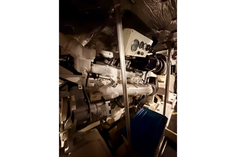 Slide: The Image of Engine room of 1982 Bertram 54 Convertible yacht, showcasing mechanical components. - 92