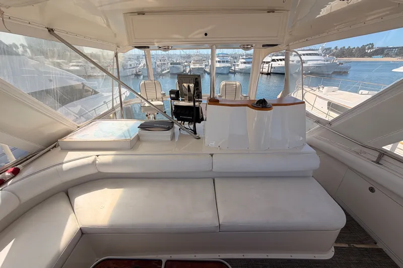 Slide: The Image of Interior view of a 1982 Bertram 54 Convertible yacht, featuring a spacious helm and seating area. - 37