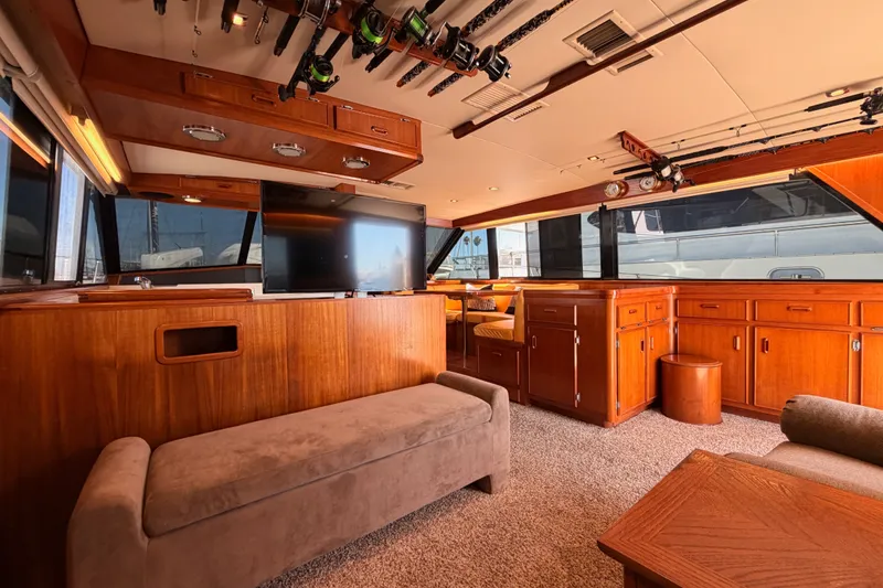 Slide: The Image of Interior of a 1982 Bertram 54 Convertible yacht with wood paneling and modern amenities. - 53