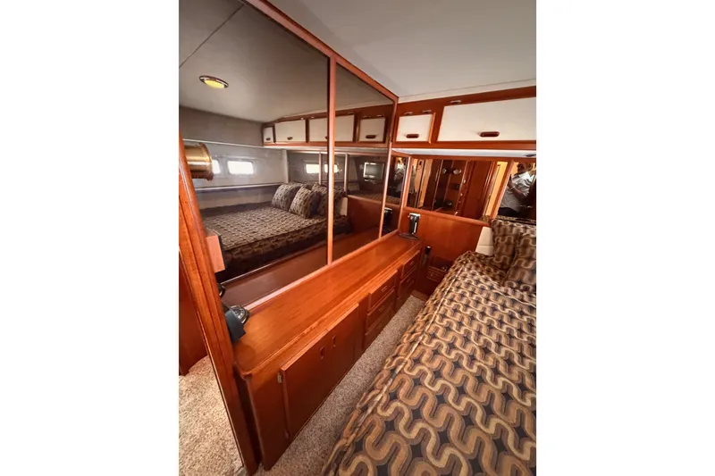 Slide: The Image of Luxurious cabin interior of 1982 Bertram 54 Convertible yacht with wood finishes. - 78