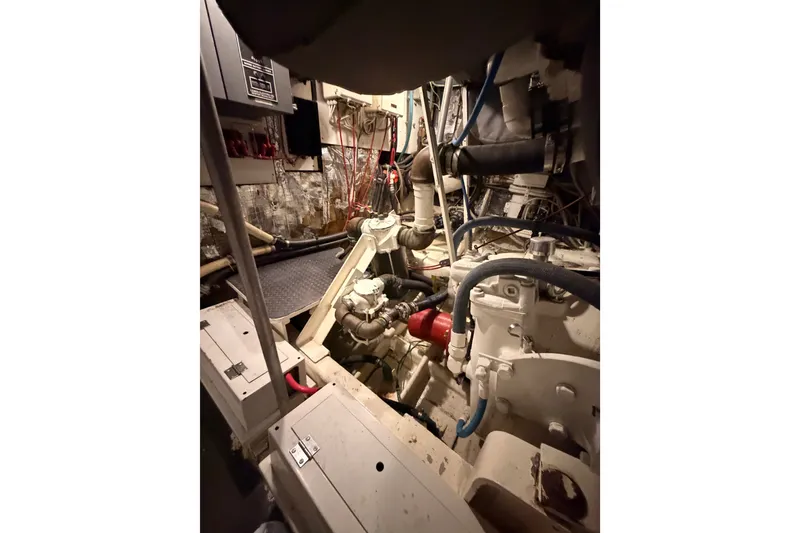 Slide: The Image of Engine room of a 1982 Bertram 54 Convertible yacht, showcasing mechanical components. - 96