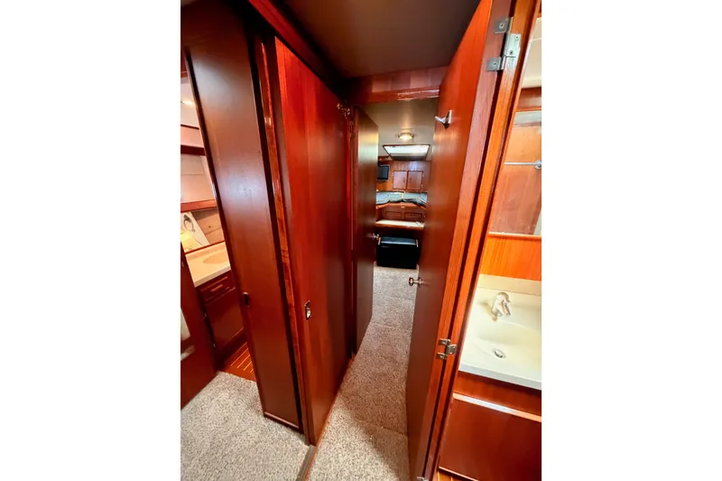 Slide: The Image of Interior hallway of 1982 Bertram 54 Convertible yacht with wooden cabinetry and carpeted floor. - 68