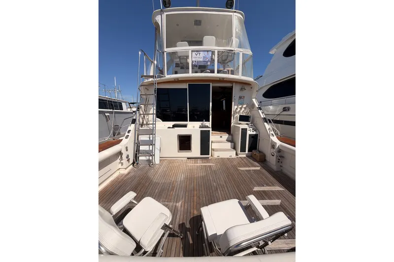 Slide: The Image of 1982 Bertram 54 Convertible yacht with spacious deck and seating area. - 17