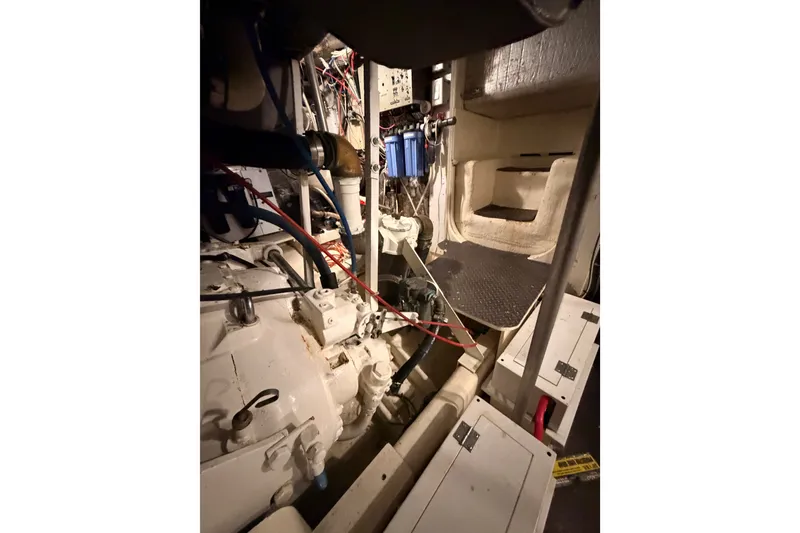 Slide: The Image of Engine room of a 1982 Bertram 54 Convertible yacht, showcasing mechanical components. - 95