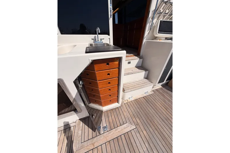 Slide: The Image of 1982 Bertram 54 Convertible yacht interior with wooden drawers and steps. - 41