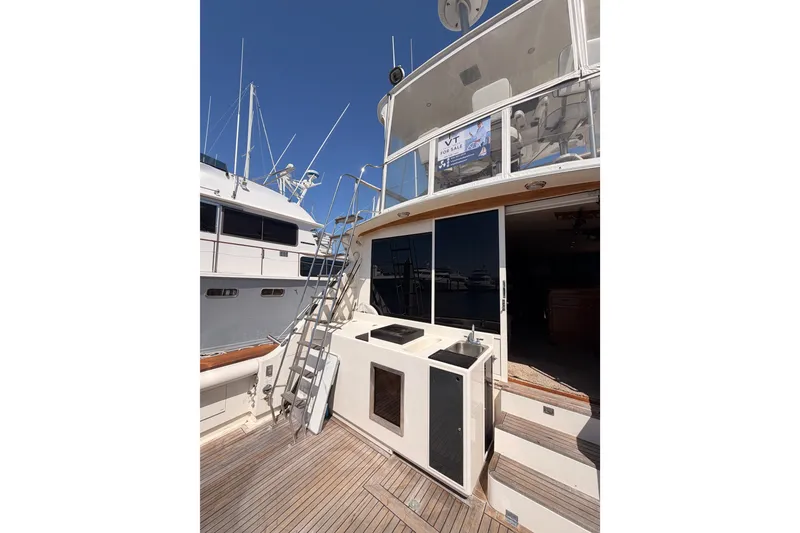 Slide: The Image of 1982 Bertram 54 Convertible yacht deck with ladder and outdoor sink. - 18