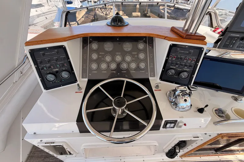 Slide: The Image of Cockpit of a 1982 Bertram 54 Convertible yacht with steering wheel and control panels. - 29
