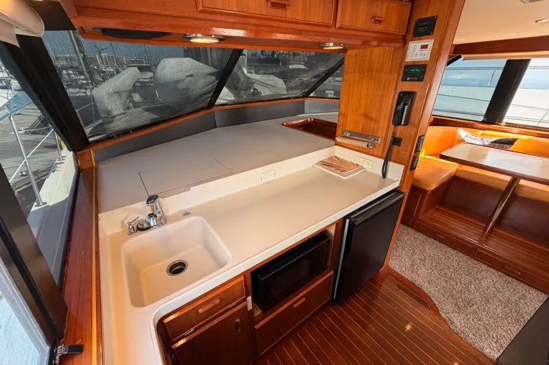 Slide: The Image of Interior of 1982 Bertram 54 Convertible yacht with kitchen and dining area. - 58