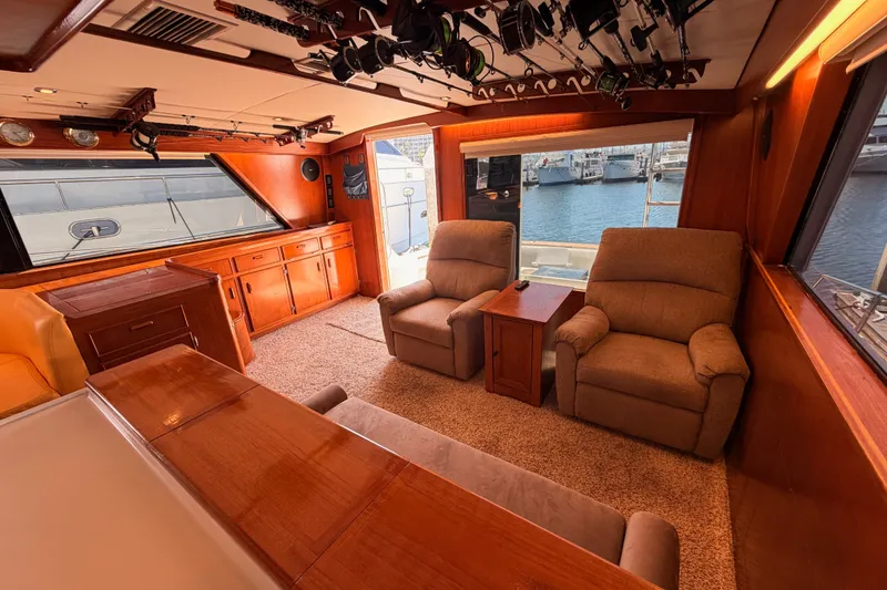 Slide: The Image of Interior of 1982 Bertram 54 Convertible yacht with cozy seating and wood finishes. - 50
