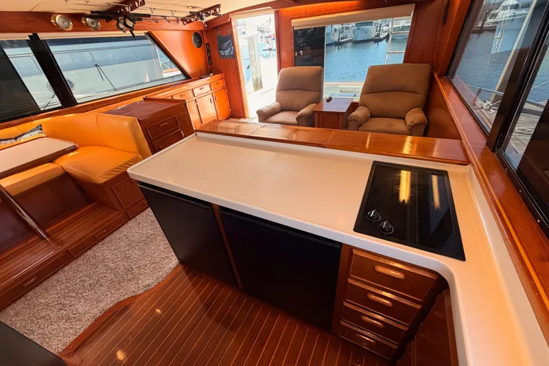 Slide: The Image of Interior of a 1982 Bertram 54 Convertible yacht with wood finishes and seating area. - 59