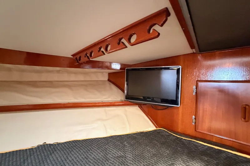 Slide: The Image of Interior cabin of 1982 Bertram 54 Convertible with TV and wooden accents. - 72