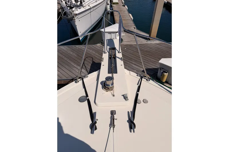 Slide: The Image of Bow view of 1982 Bertram 54 Convertible yacht docked at marina. - 23