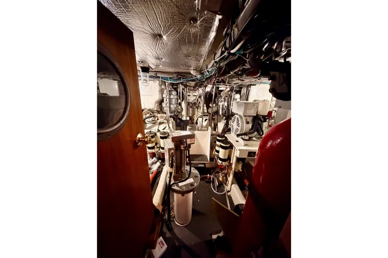 Slide: The Image of Engine room of a 1982 Bertram 54 Convertible yacht, showcasing machinery and equipment. - 87