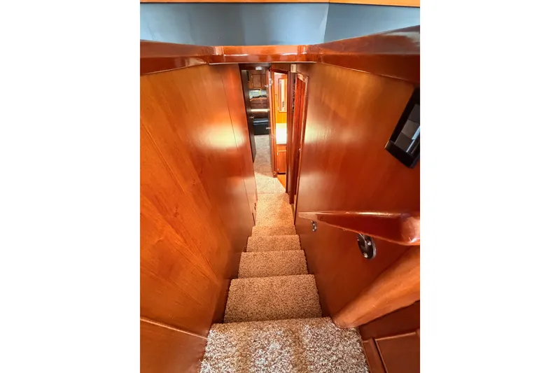 Slide: The Image of Interior staircase of 1982 Bertram 54 Convertible yacht with wooden paneling. - 62