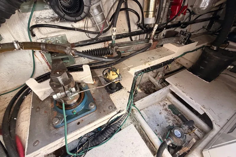 Slide: The Image of Engine room of a 1982 Bertram 54 Convertible boat, showcasing mechanical components and wiring. - 44
