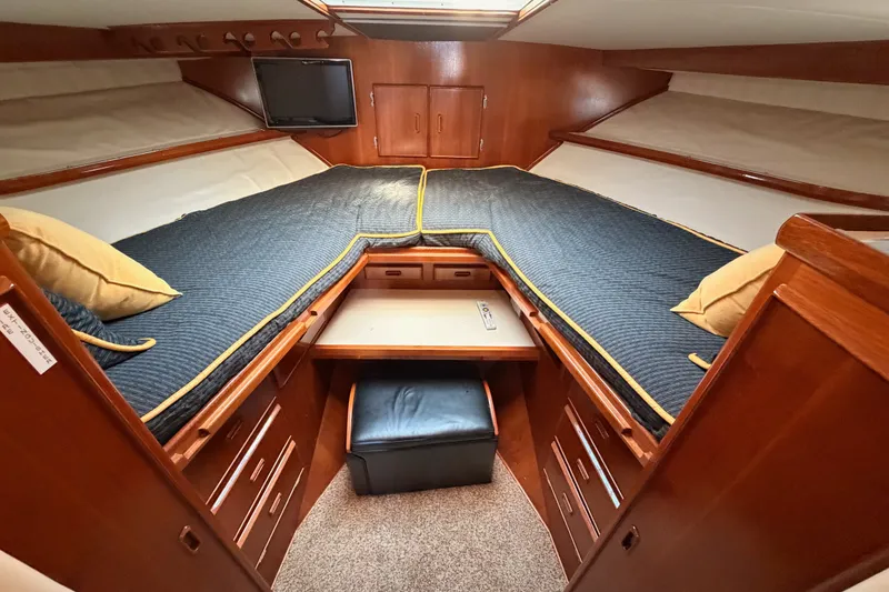 Slide: The Image of Luxurious cabin interior of 1982 Bertram 54 Convertible yacht with cozy bedding and wood finish. - 70