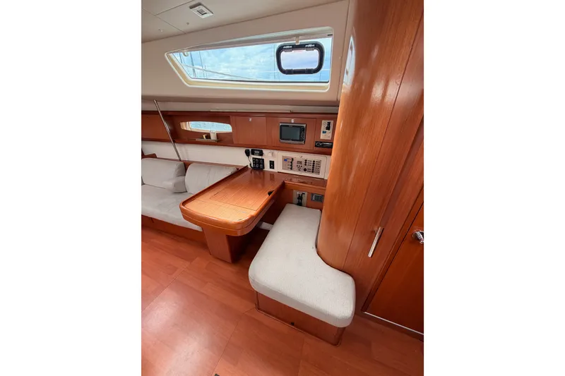 Slide: The Image of Interior of 2008 Beneteau 49 yacht with wooden furnishings and navigation equipment. - 54