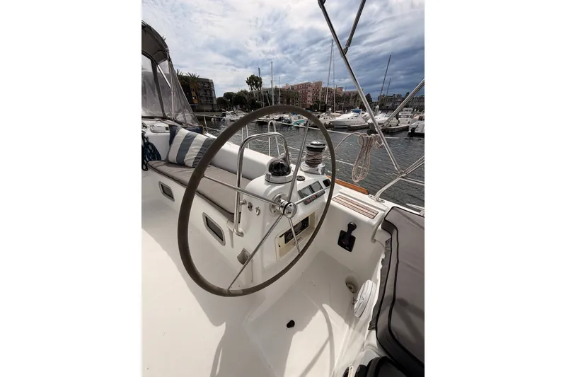Slide: The Image of Cockpit of 2008 Beneteau 49 sailboat with steering wheel, docked in marina. - 31
