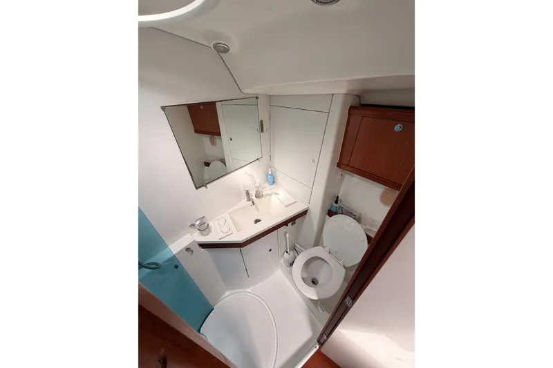 Slide: The Image of Bathroom interior of 2008 Beneteau 49 yacht, featuring sink, toilet, and mirror. - 67