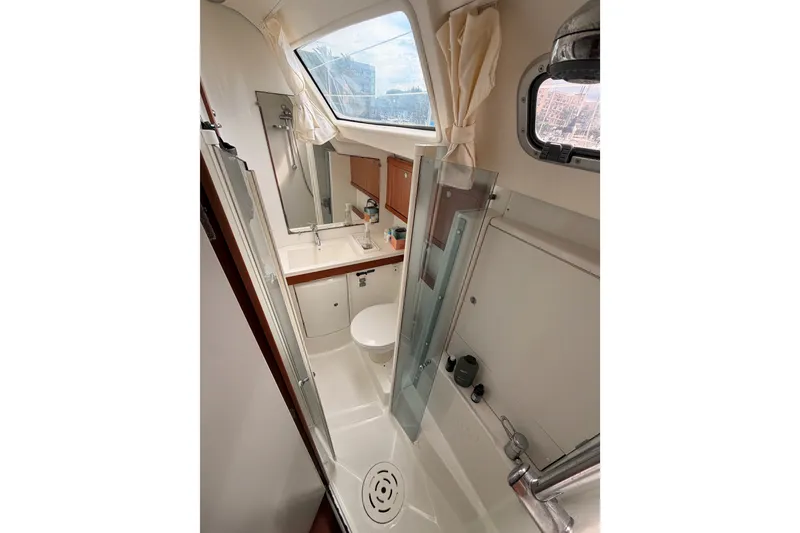 Slide: The Image of Bathroom interior of a 2008 Beneteau 49 yacht, featuring a shower and sink. - 52