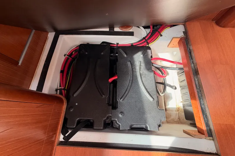Slide: The Image of Battery compartment of a 2008 Beneteau 49 sailboat with visible wiring. - 88