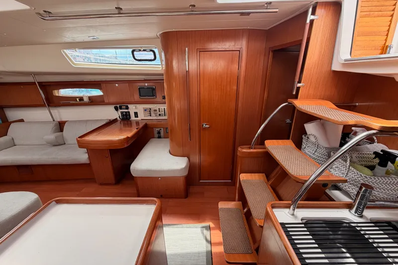 Slide: The Image of Interior of a 2008 Beneteau 49 yacht, featuring wood finishes and modern amenities. - 50
